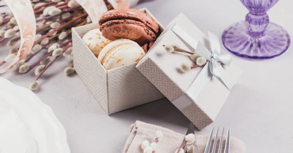 A colourful assortment of French macarons neatly arranged inside a stylish, custom-printed white macaron box.